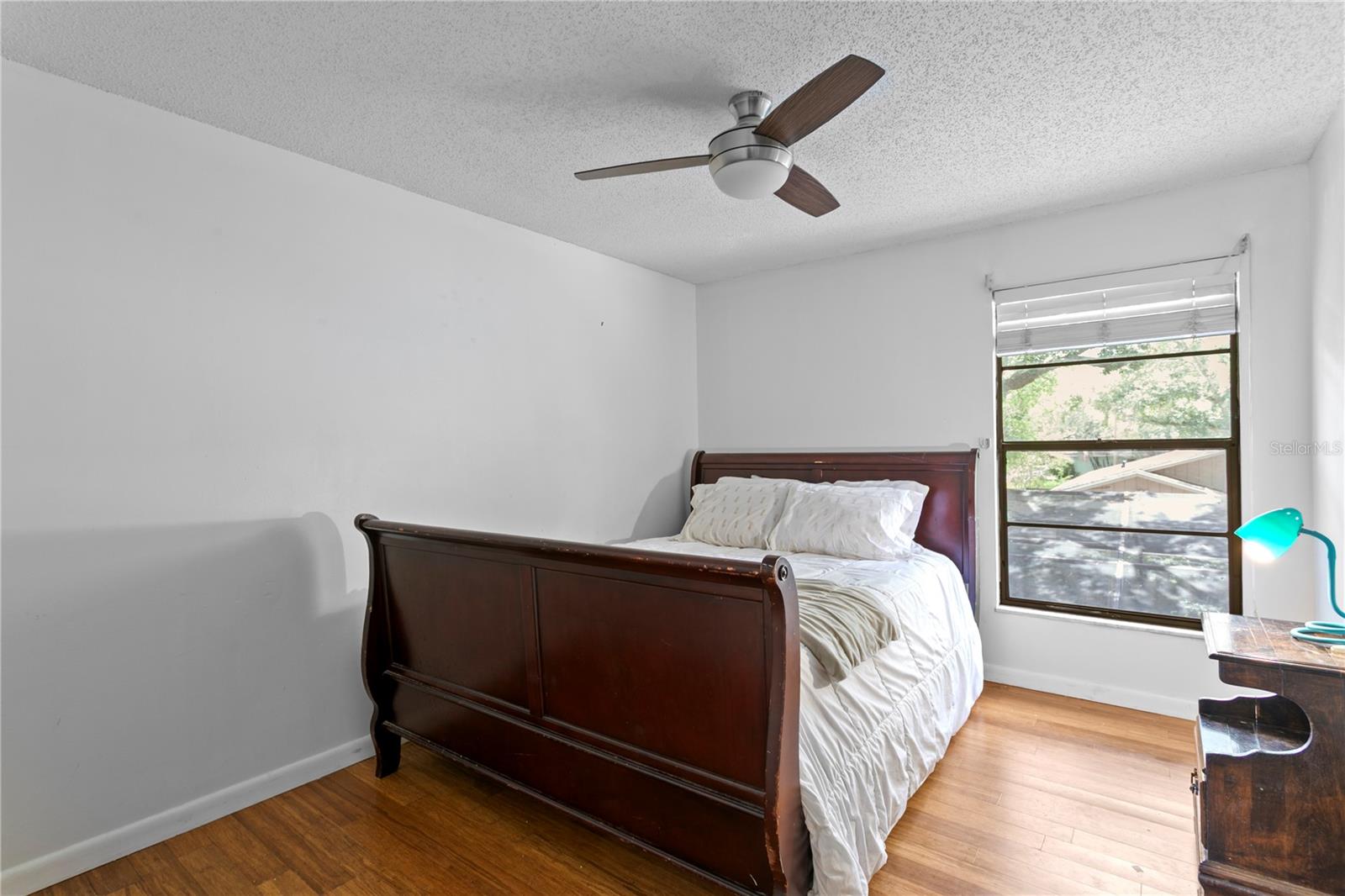 Bedroom 2 with hard wood floors and ceiling fan