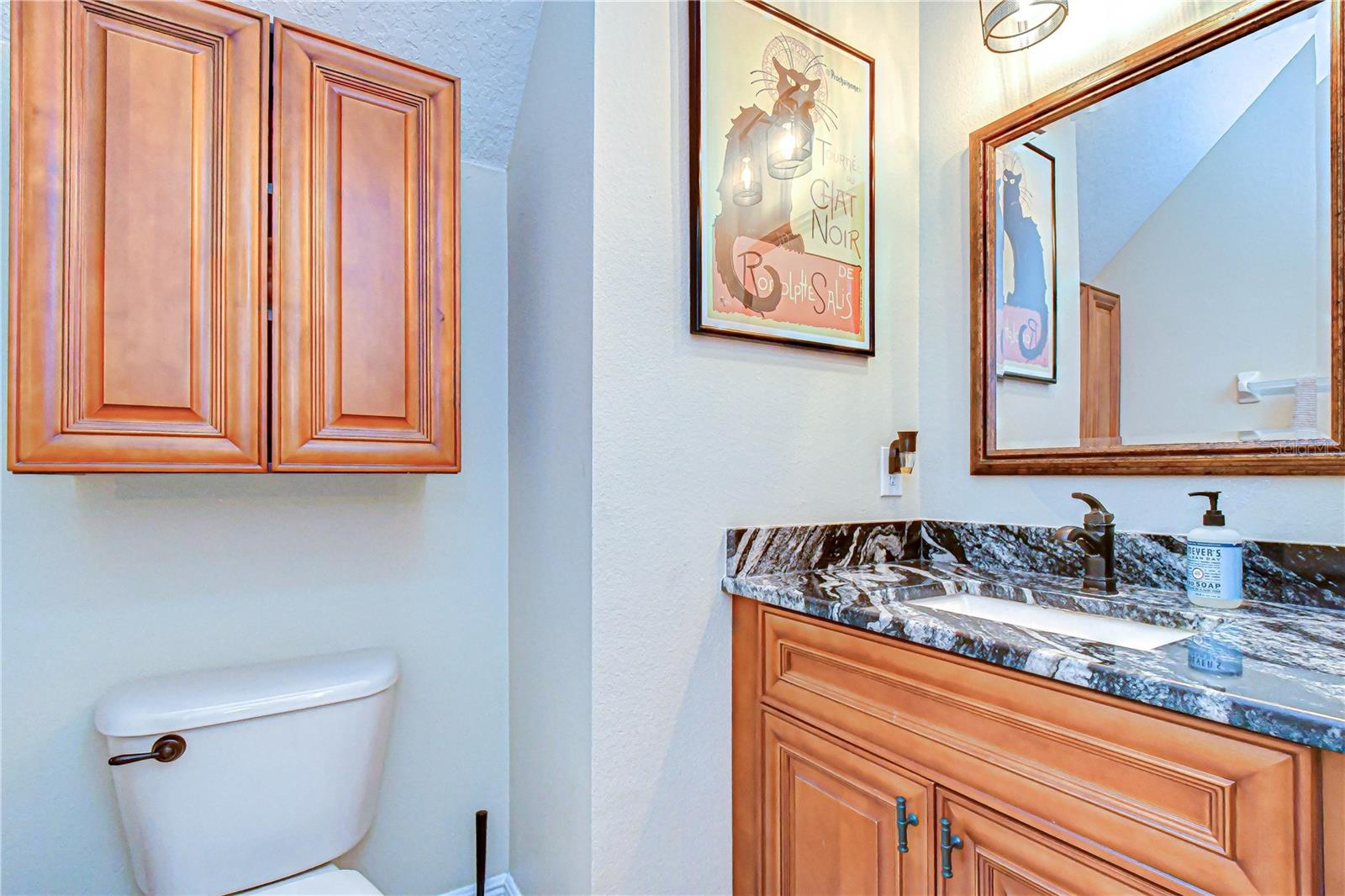 Clean and convenient half bath on the main level featuring updated fixtures.