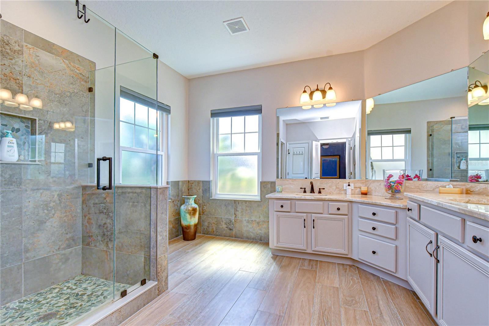 En-suite bath featuring dual vanities and spacious shower.