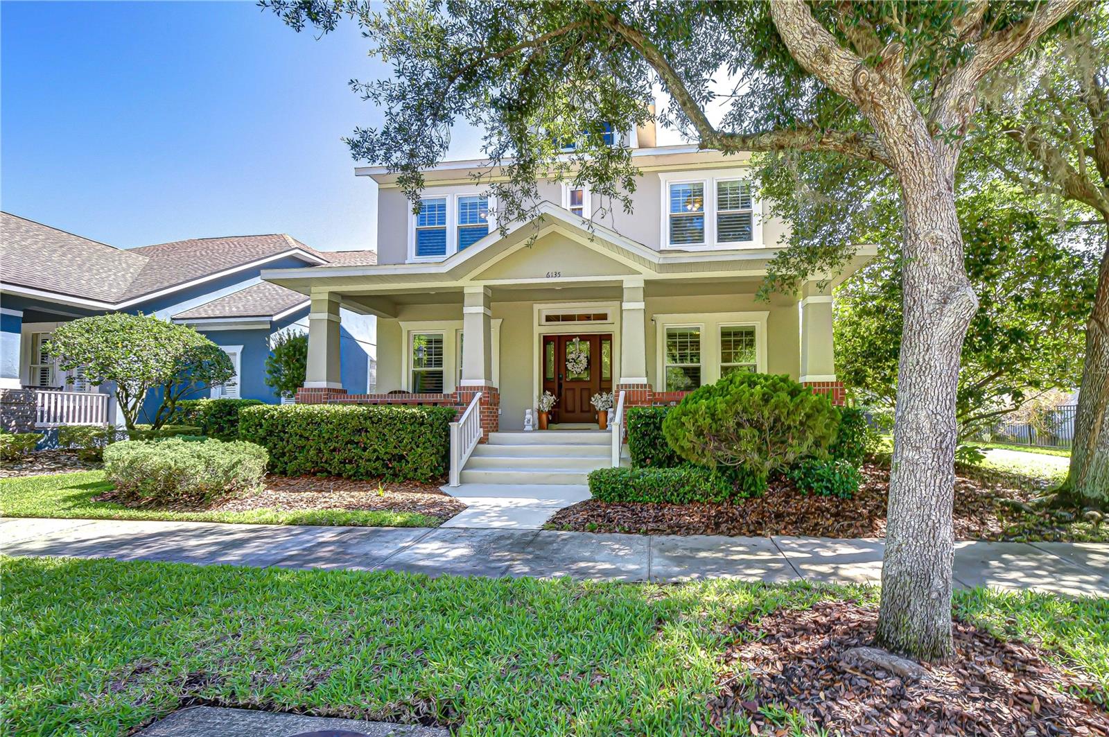 Classic columns, brick accents, and welcoming front porch create a timeless exterior.