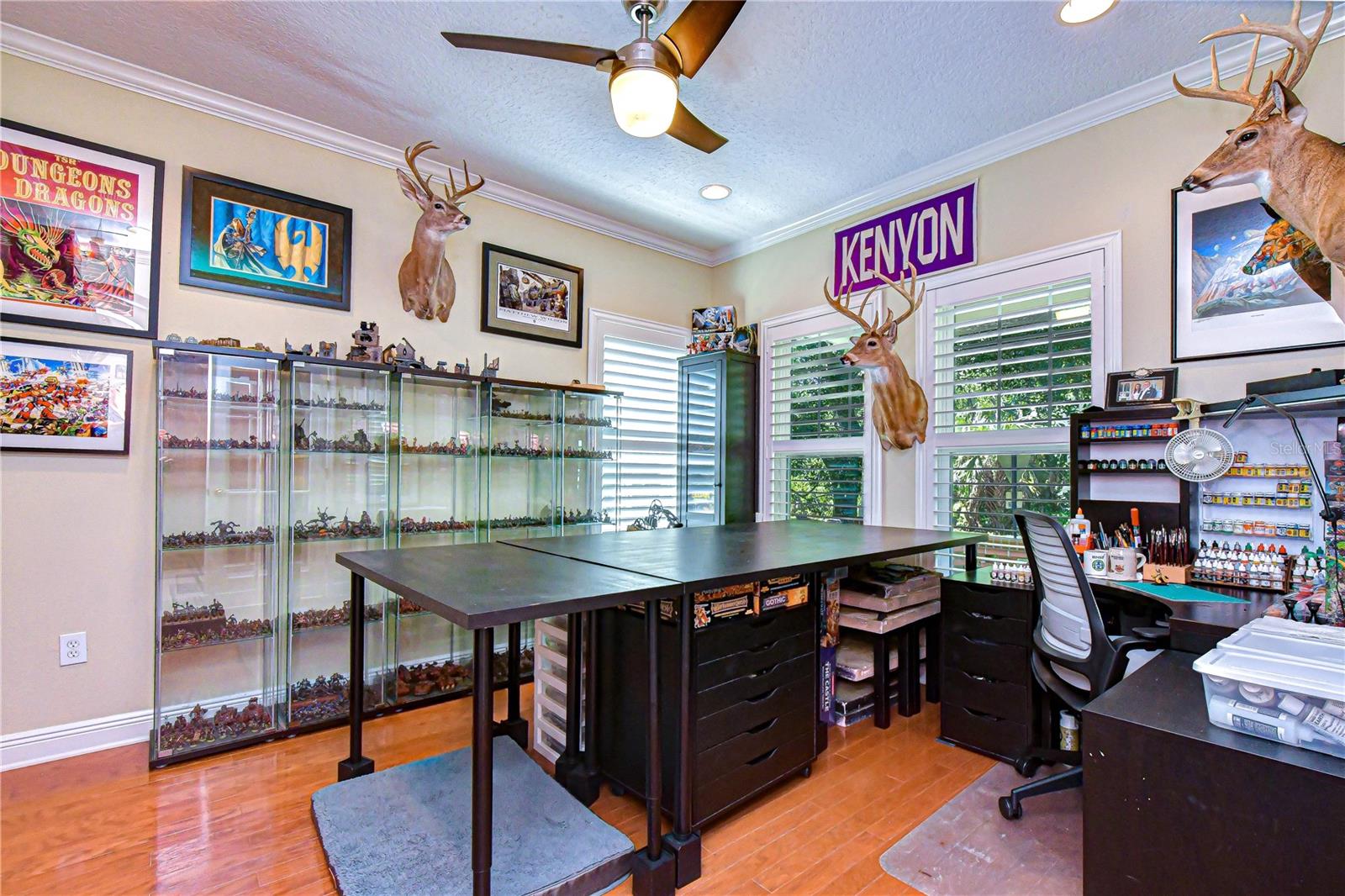 Spacious and bright den filled with natural light and featuring wide baseboards.