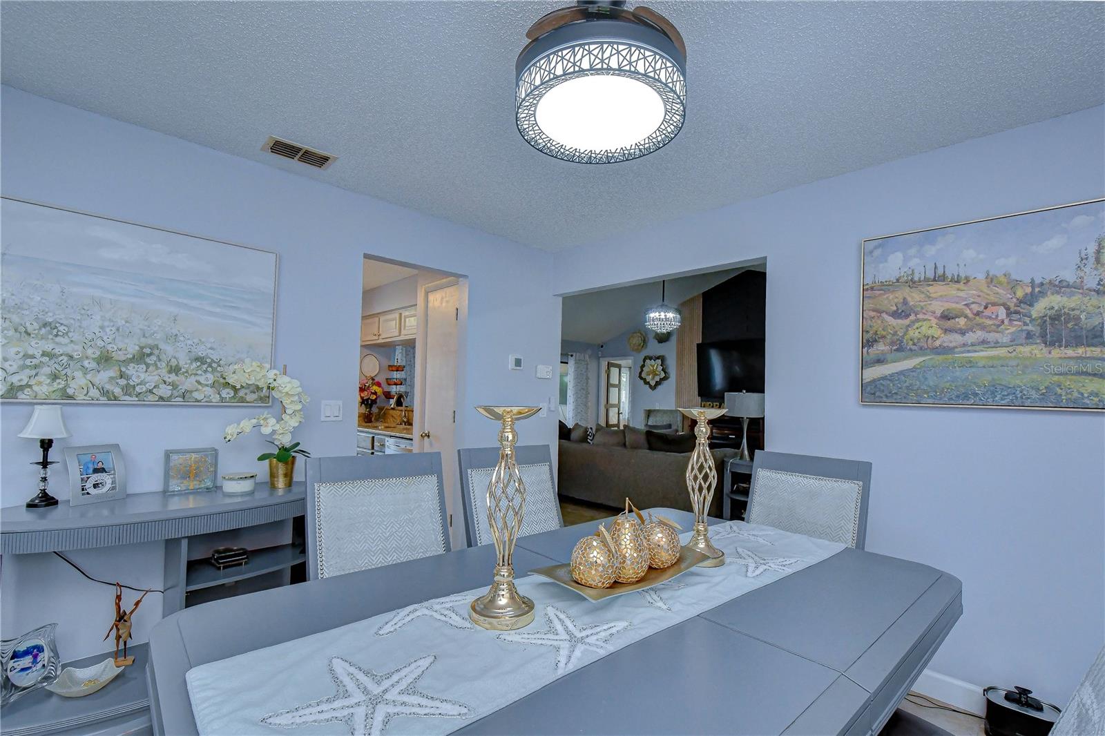 View from behind dining area toward kitchen entry and living room