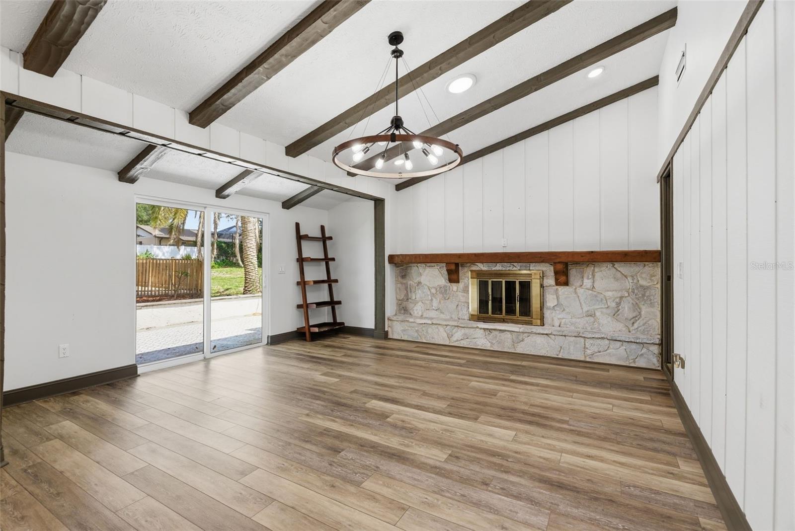 Family Room with Wood Burning Stone Fireplace, Beamed Ceiling