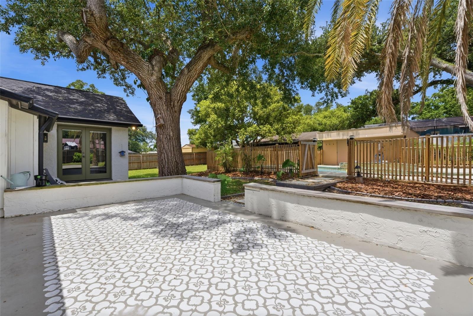 French doors to yard, patio and pool