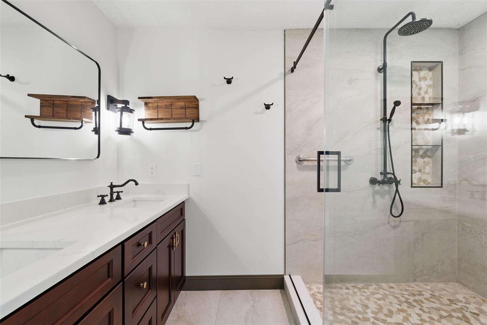 Primary bathroom with dual sinks,seamless glass shower