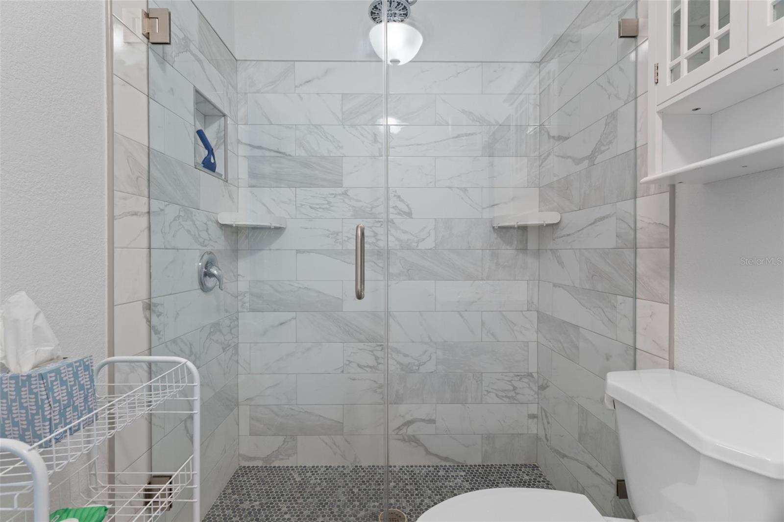 Updated En-Suite Bath with Beautiful Tile and Glass Doors