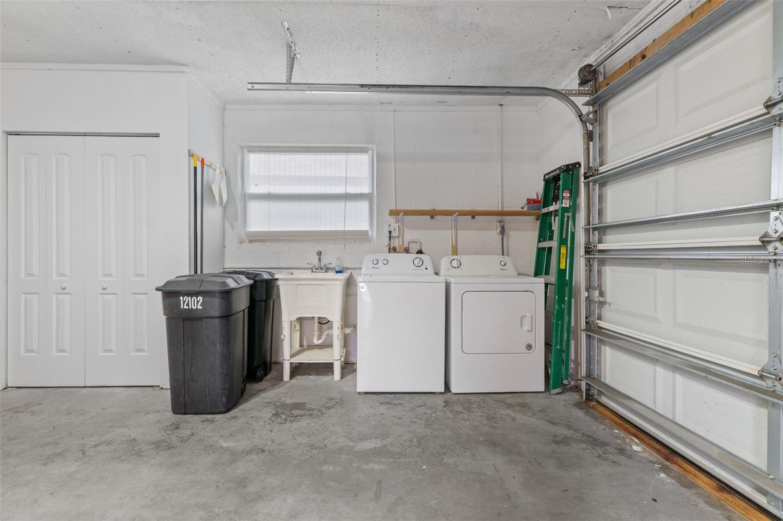 Laundry Area with Storage Closets and Laundry Sink