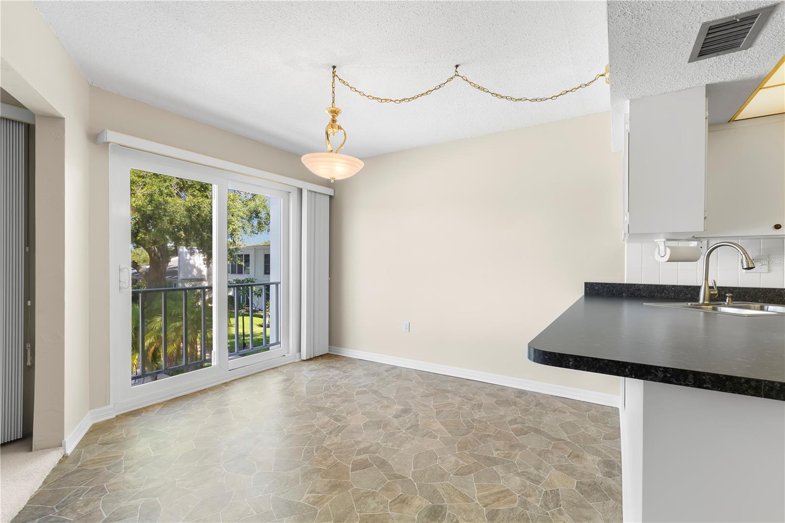 Dining room with impact sliders to balcony overlook