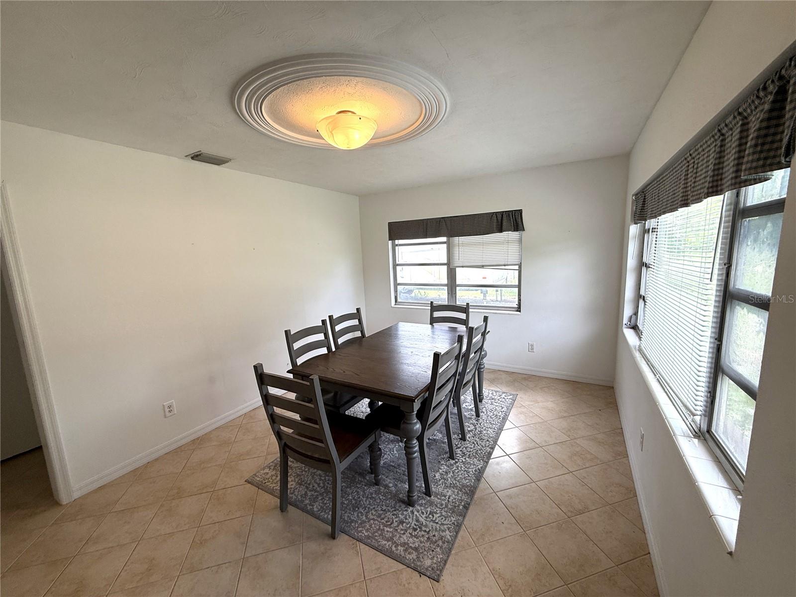 Dining Room with tile flooring and custom plaster ceiling