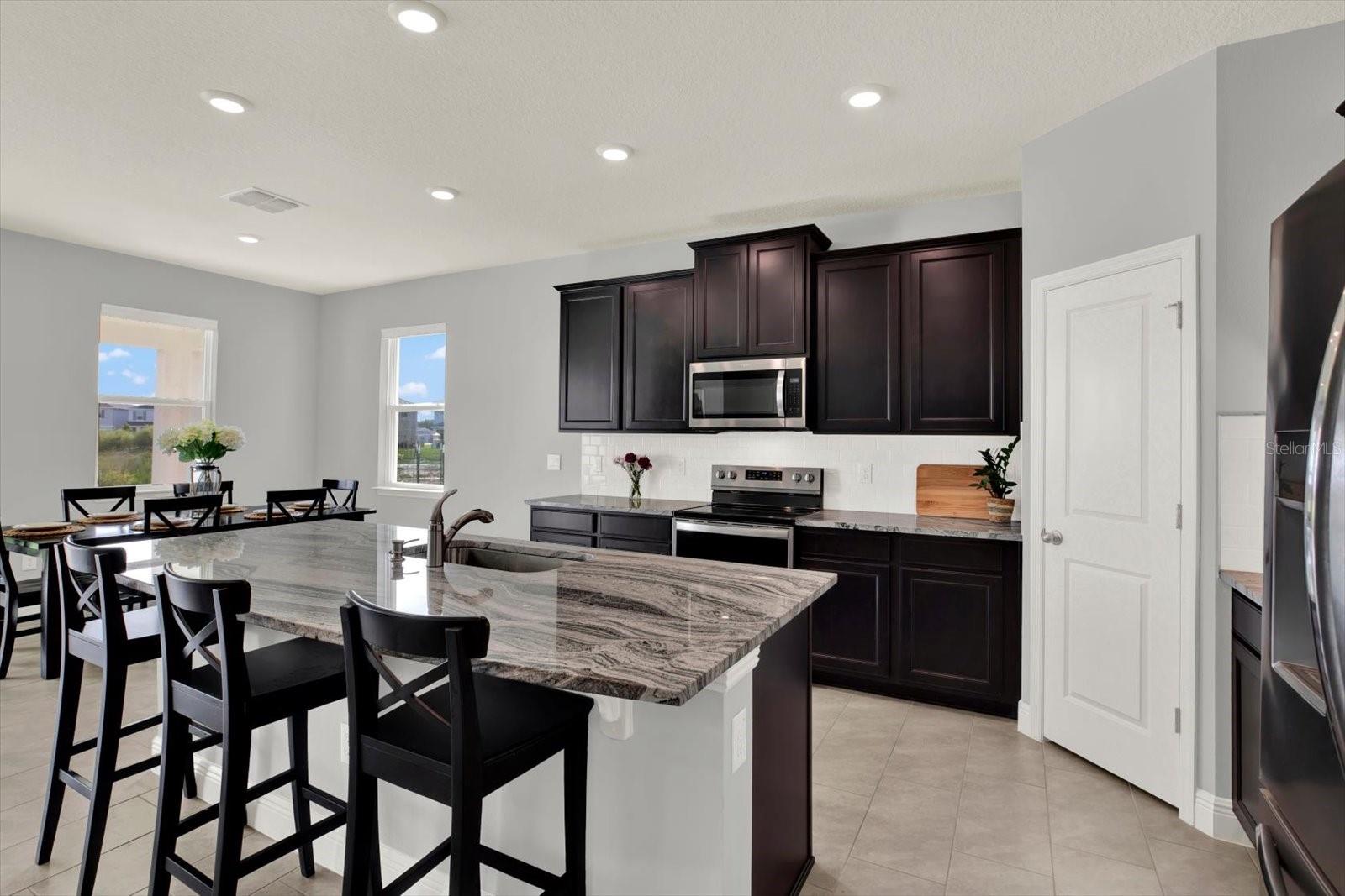 Kitchen features stainless steel appliances and beautiful granite counters