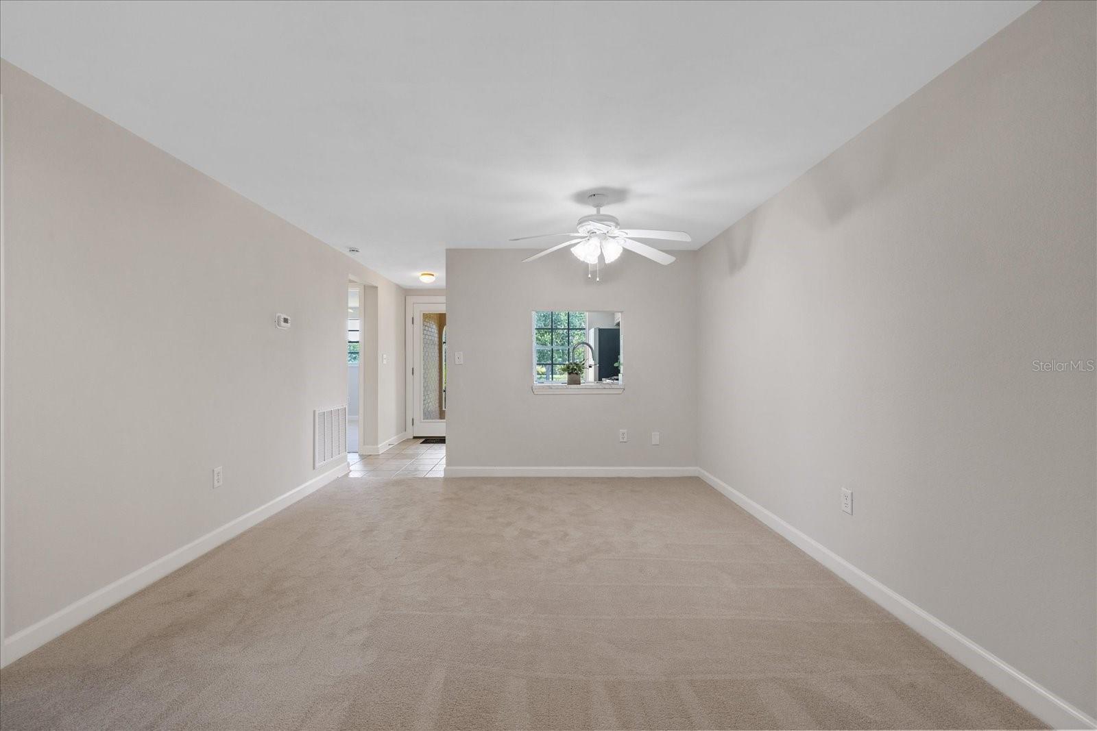 Living room looking toward kitchen and entry