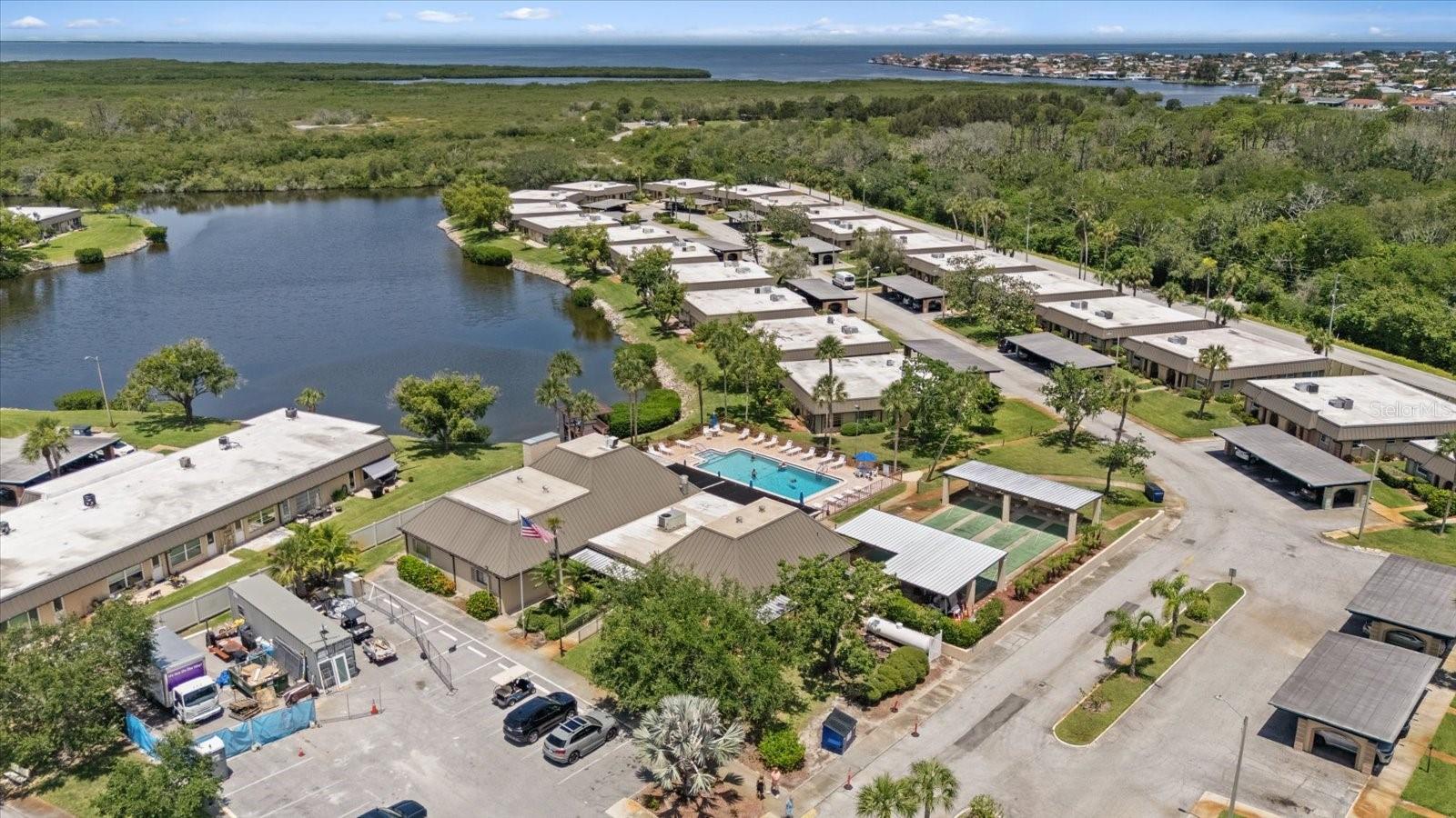 Aerial view of pool and courts with Gulf of America nearby Anclote park