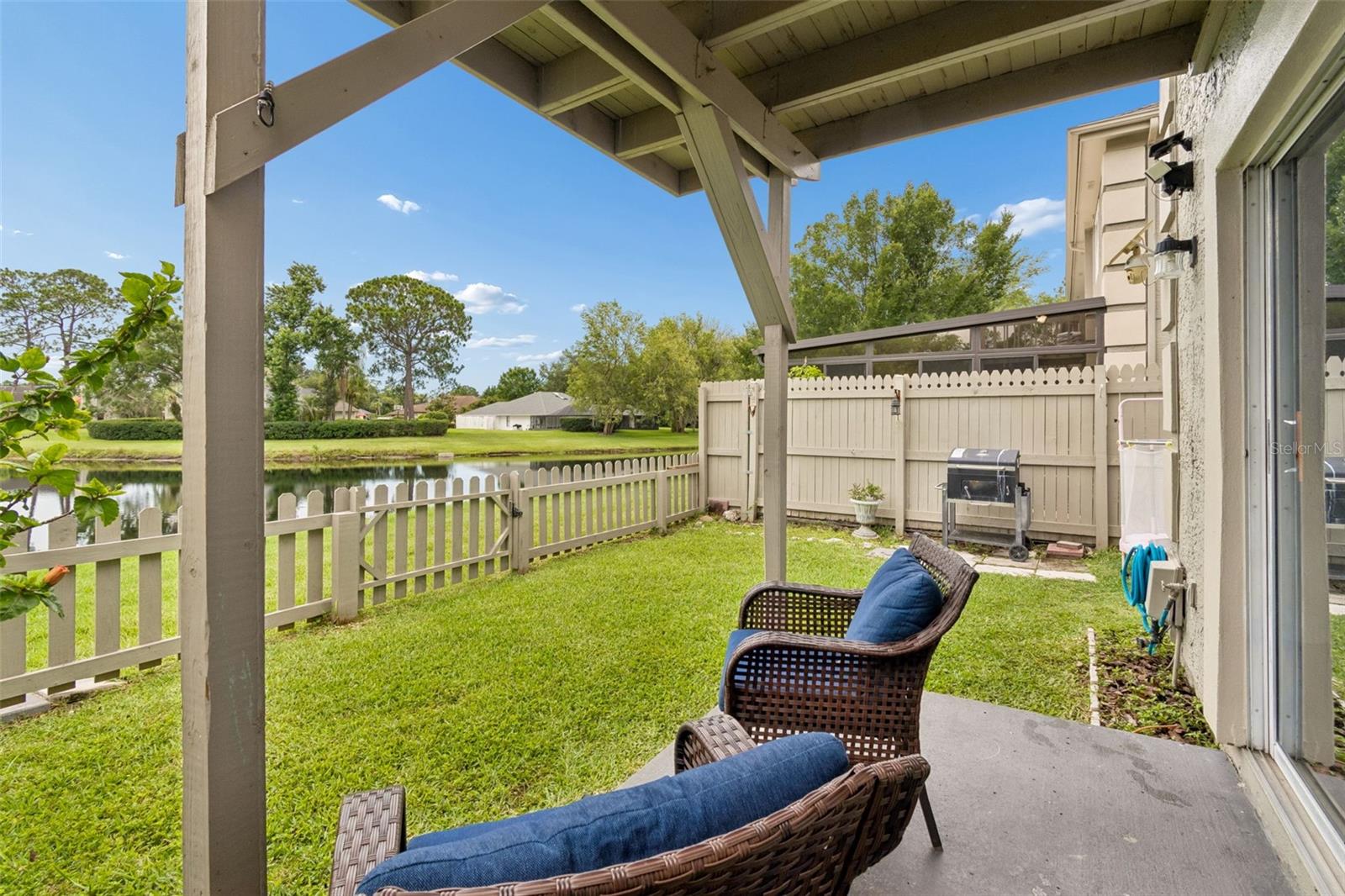Private fenced backyard with serene pond views