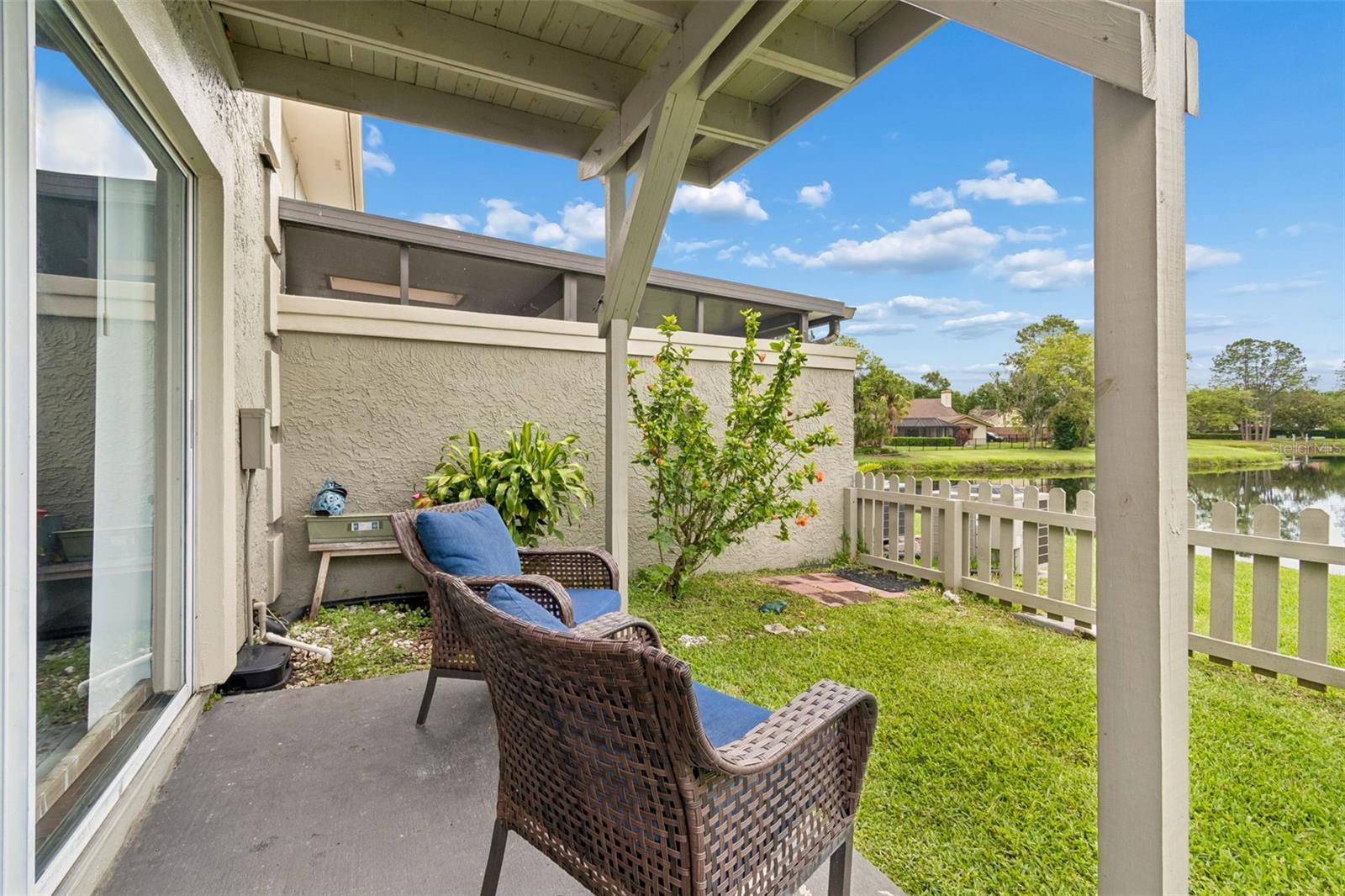 Fenced backyard overlooking a tranquil pond
