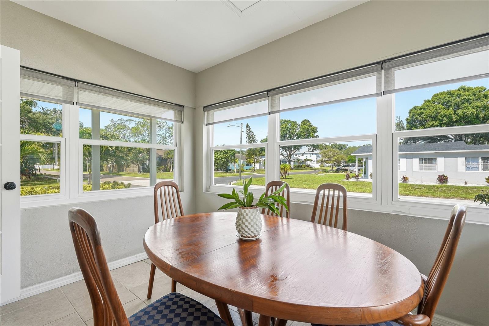 Spacious and light-filled sunroom currently used as a dining space.