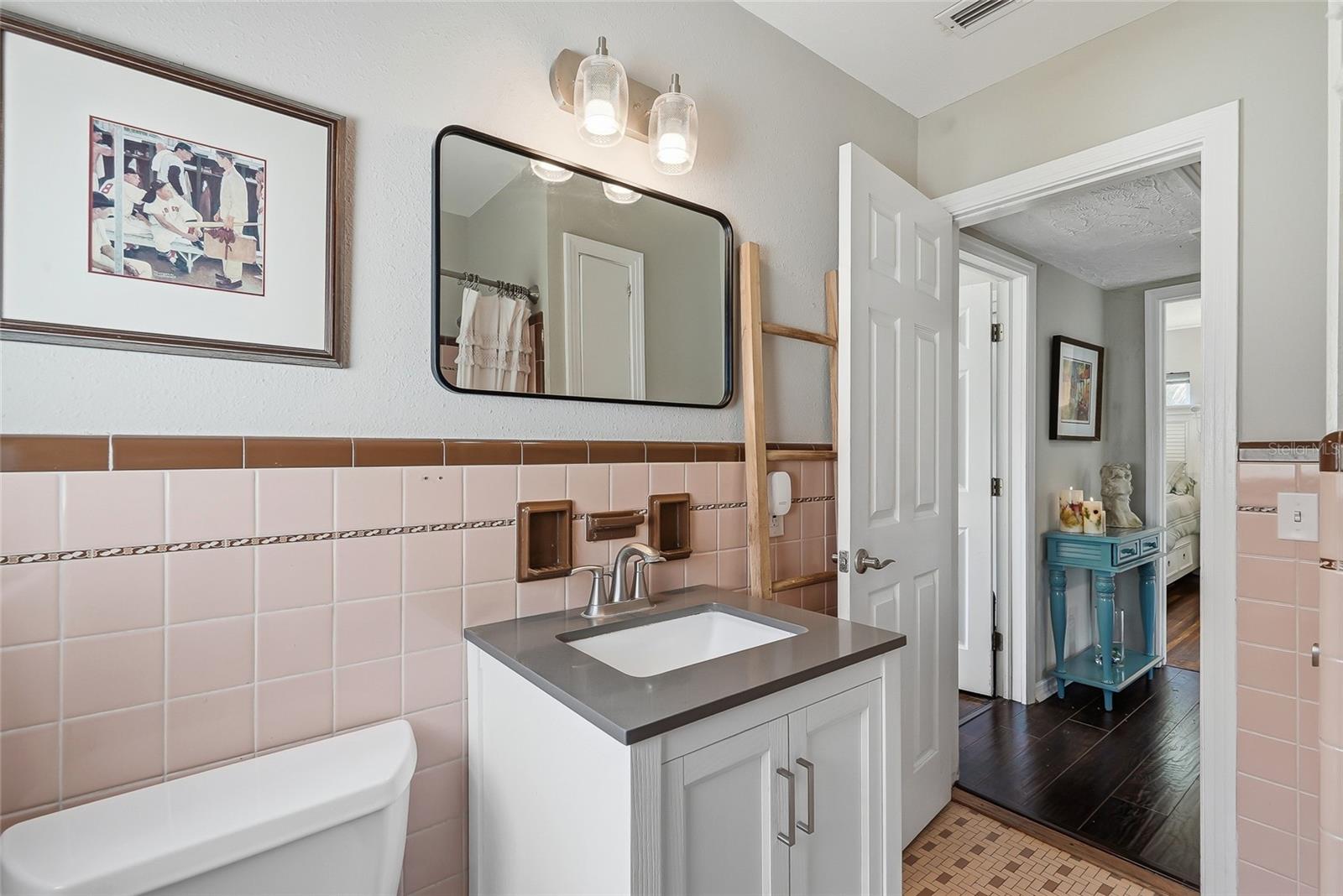 Hall bath with updated vanity sink.