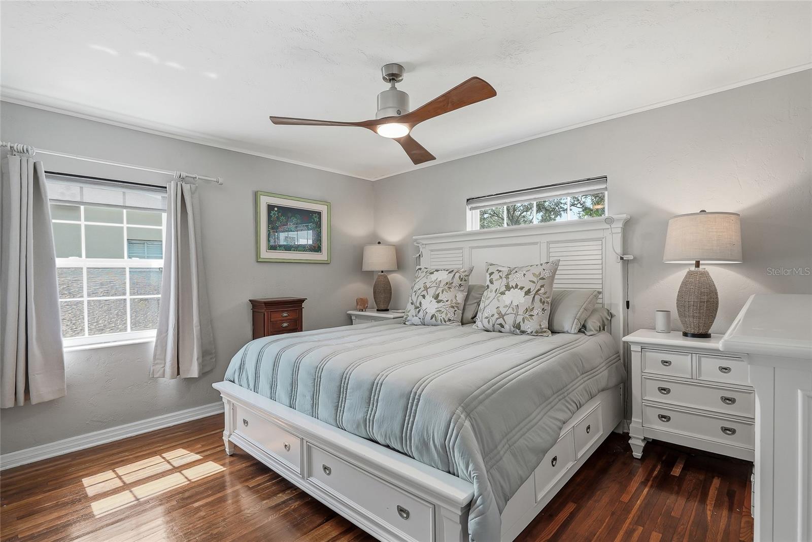 Large front bedroom with beautifully-restored hardwood floors has plenty of space for a king-sized bed.