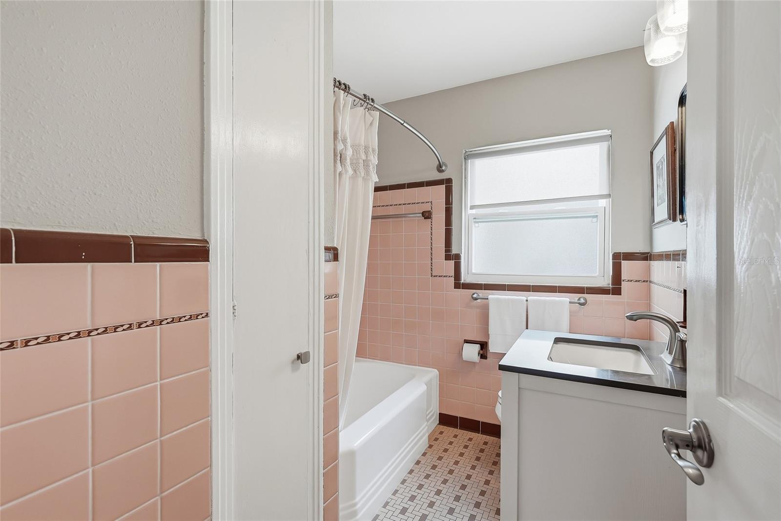 Retro-chic hall bathroom in the front of the home.