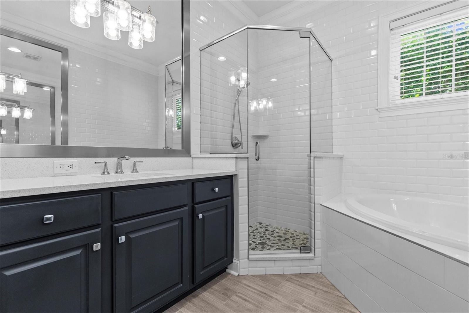 Subway tile wall surrounds shower and tub.