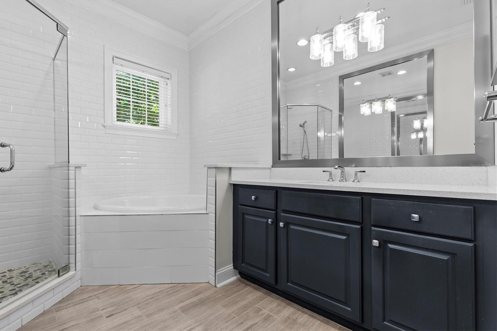 Two large vanities with wood cabinetry and stainless steel fixtures.