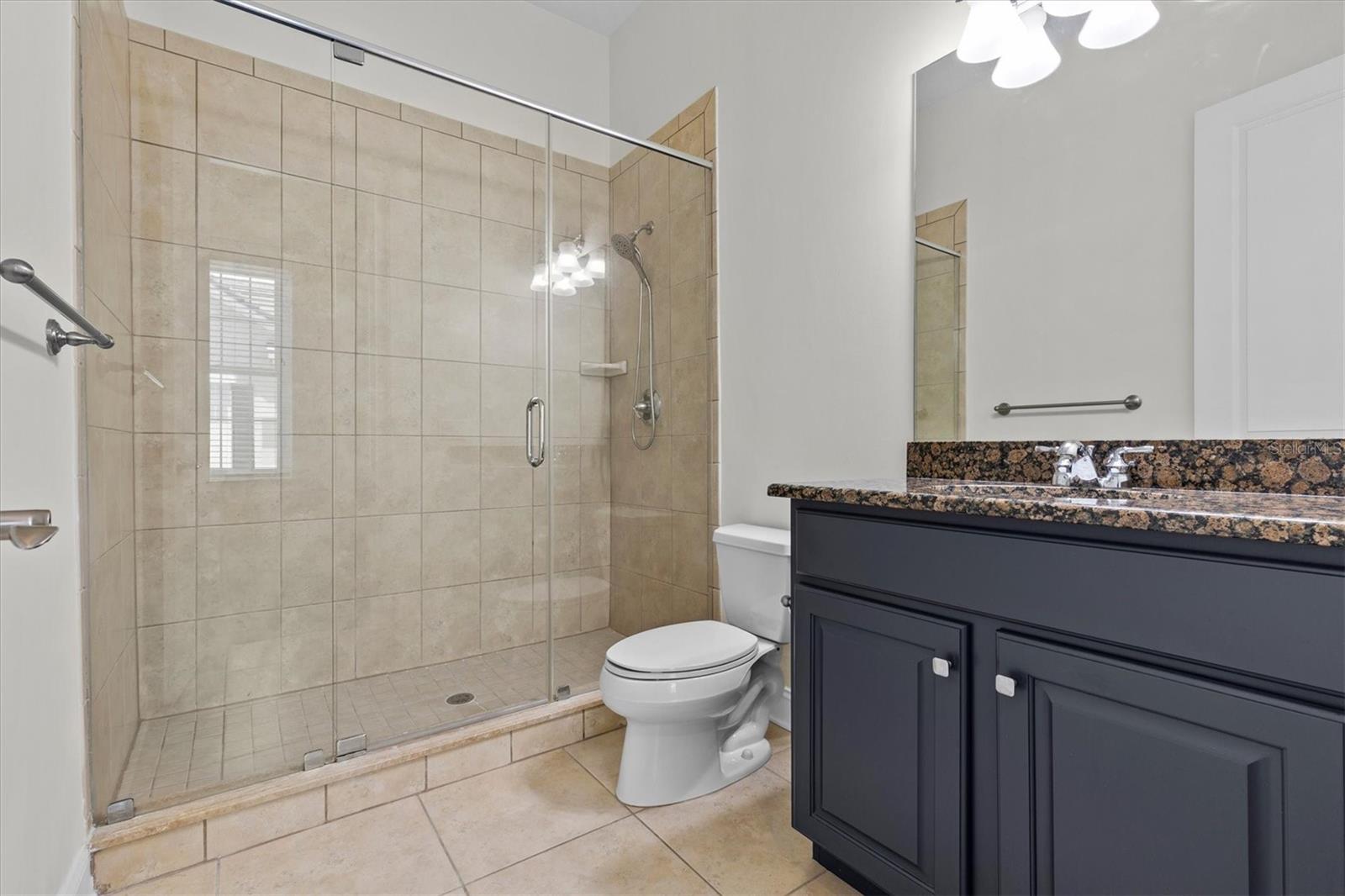 Full bathroom with glass enclosed shower.