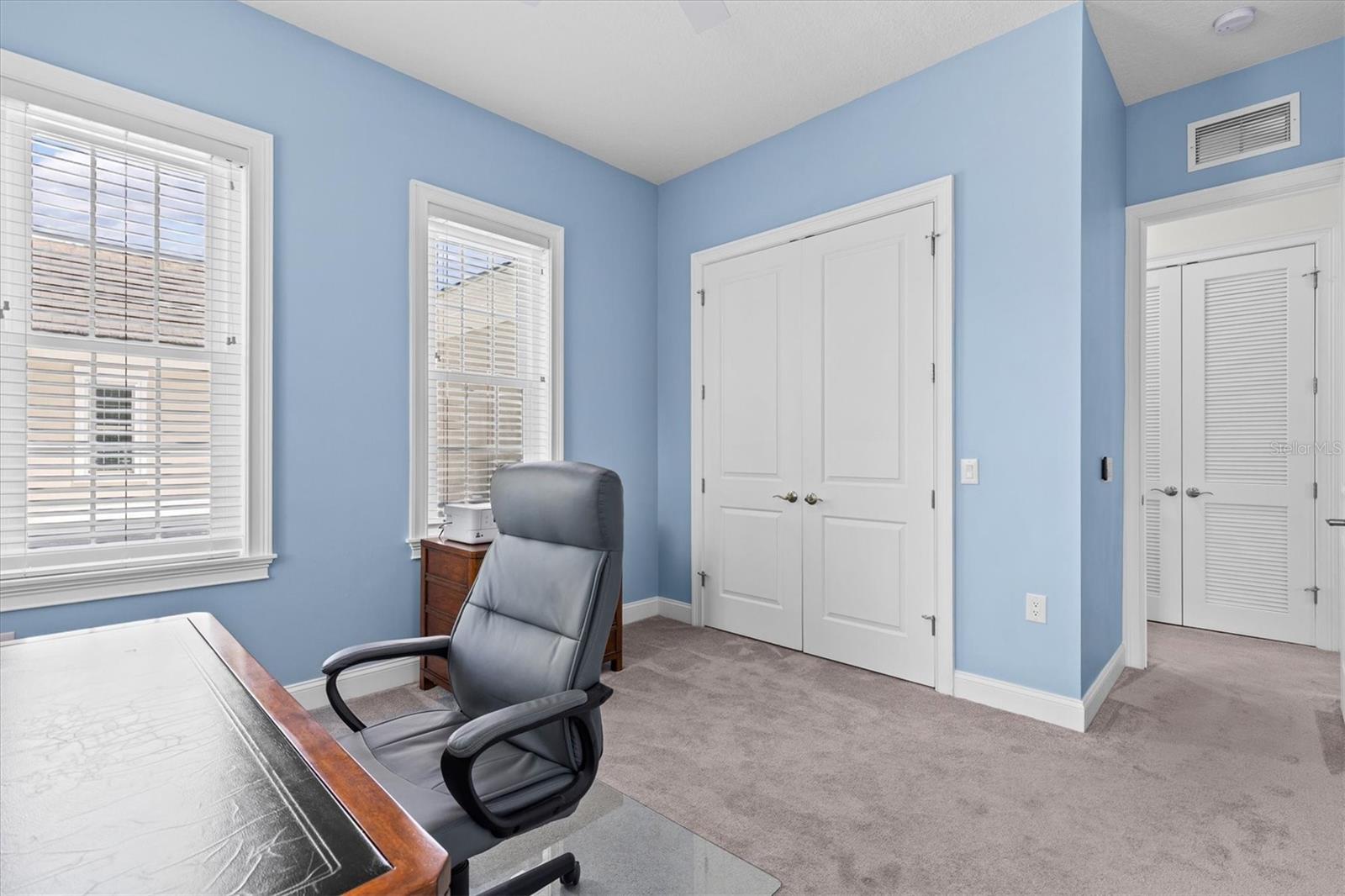 Double built-in closet with more storage across the hallway.