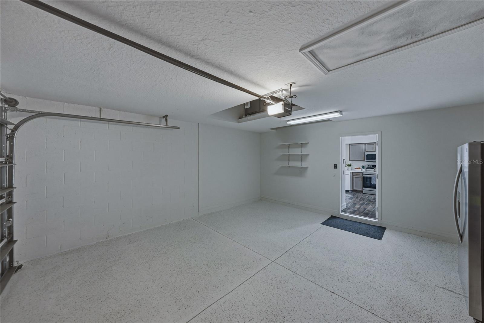 Garage with Extra Garage Refrigerator and Epoxy Floors
