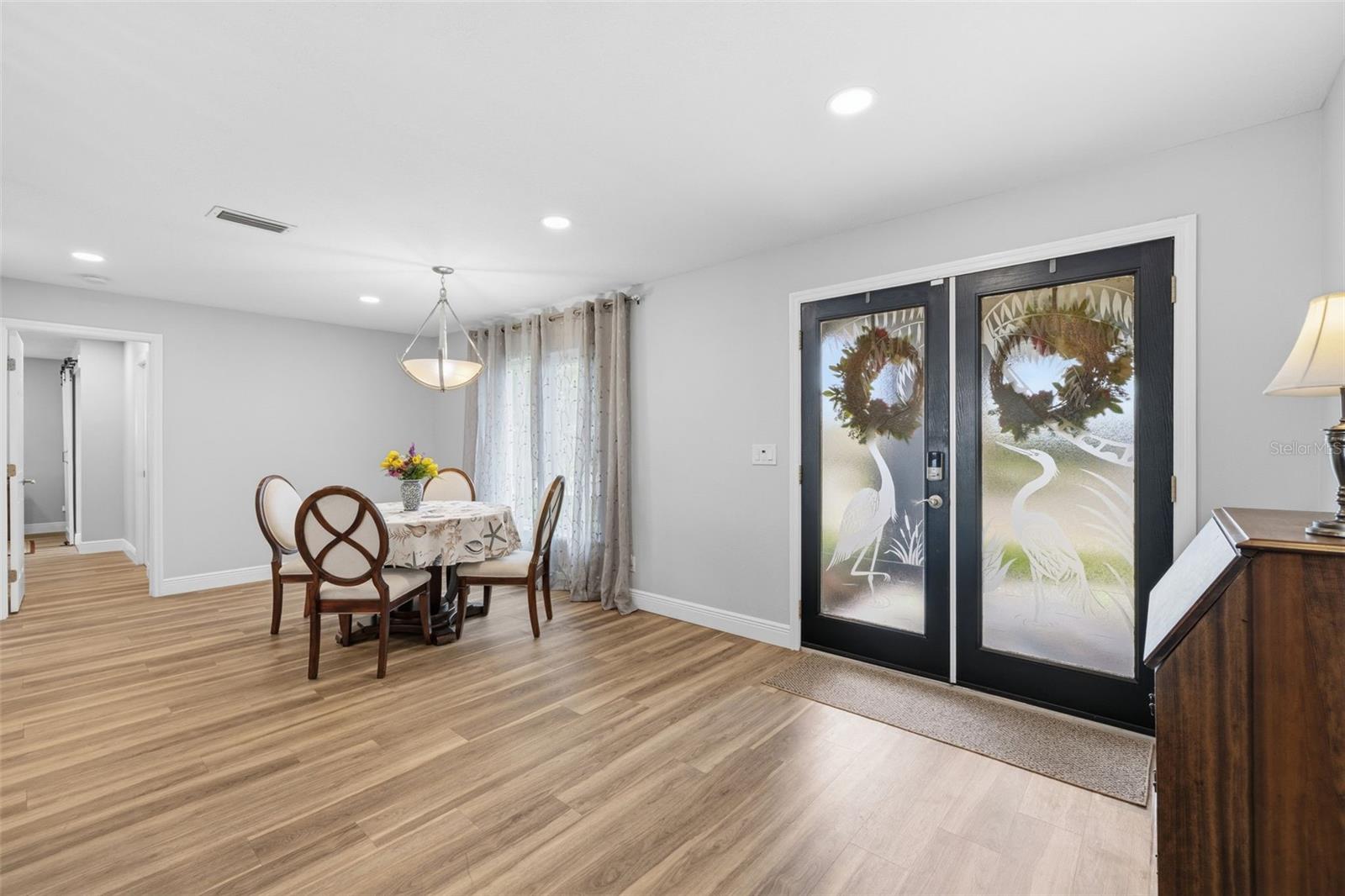 Grand Front Entry with Etched with Great Blue Herons Energy Efficient Double Doors! Yes an easy move in!  Plenty of extra LED Can lighting to turn on lighting you need!