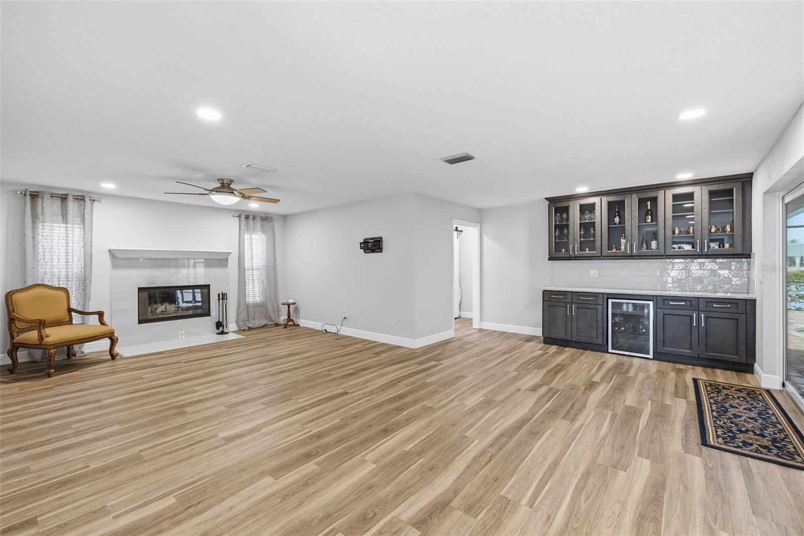Large Great Room offers seating options that makes sense! The Fireplace has Travertine Tile! Love this feature when we get those chilly days!