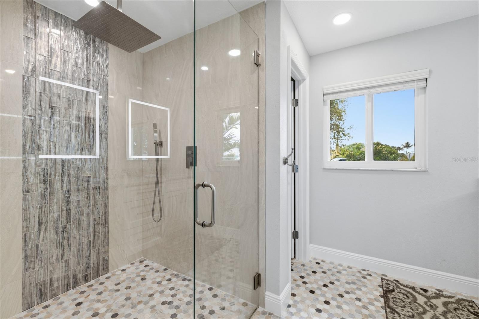 You see the Door to the Water Closet! Yes it is enclosed! Marble Flooring continues throughout due to the Shower is a zero Entry Shower! Nothing to Trip over!