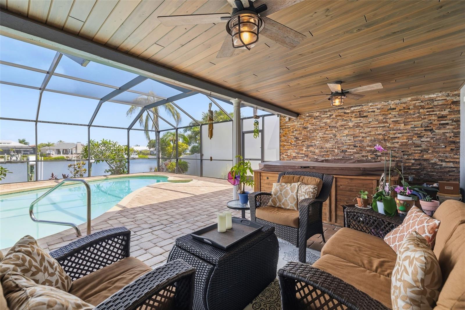 Very inviting Entertainment Area with DeGeorge Wood Ceiling! Yes that quality Matters as the boards are coated on all sides to protect its Longevity!  Hot Tub is an amazing feature!