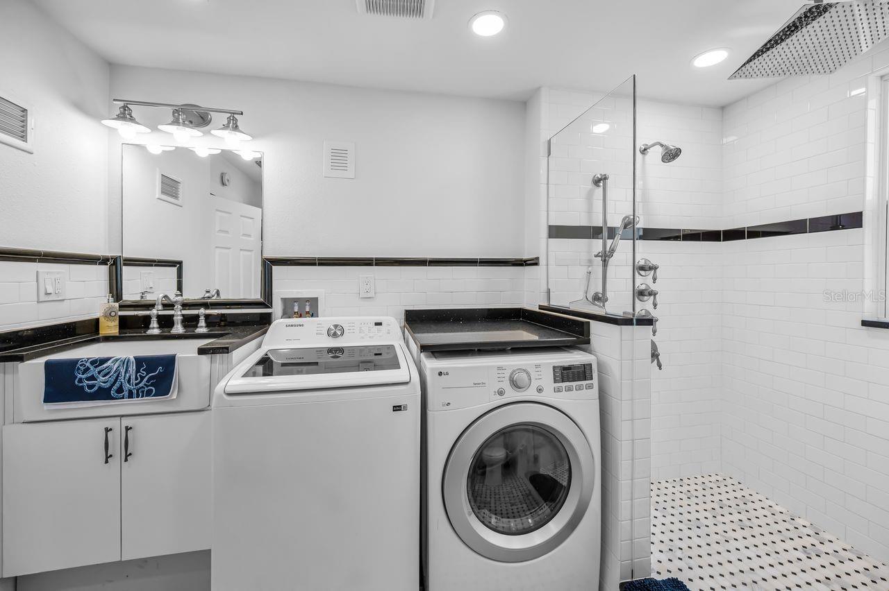 Upstairs laundry room with a full guest bath.