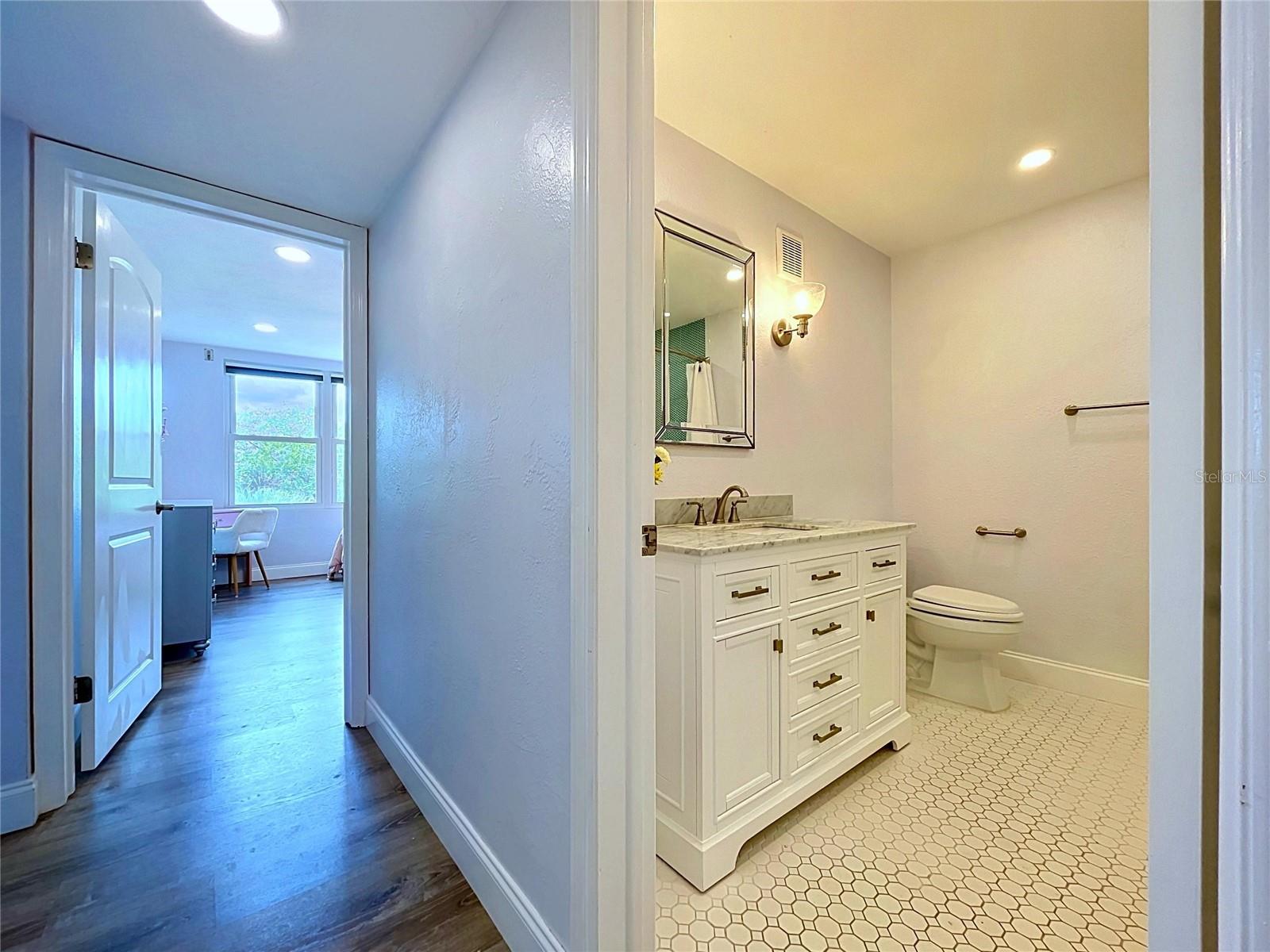Hallway to 2nd bathroom and 3rd bedroom
