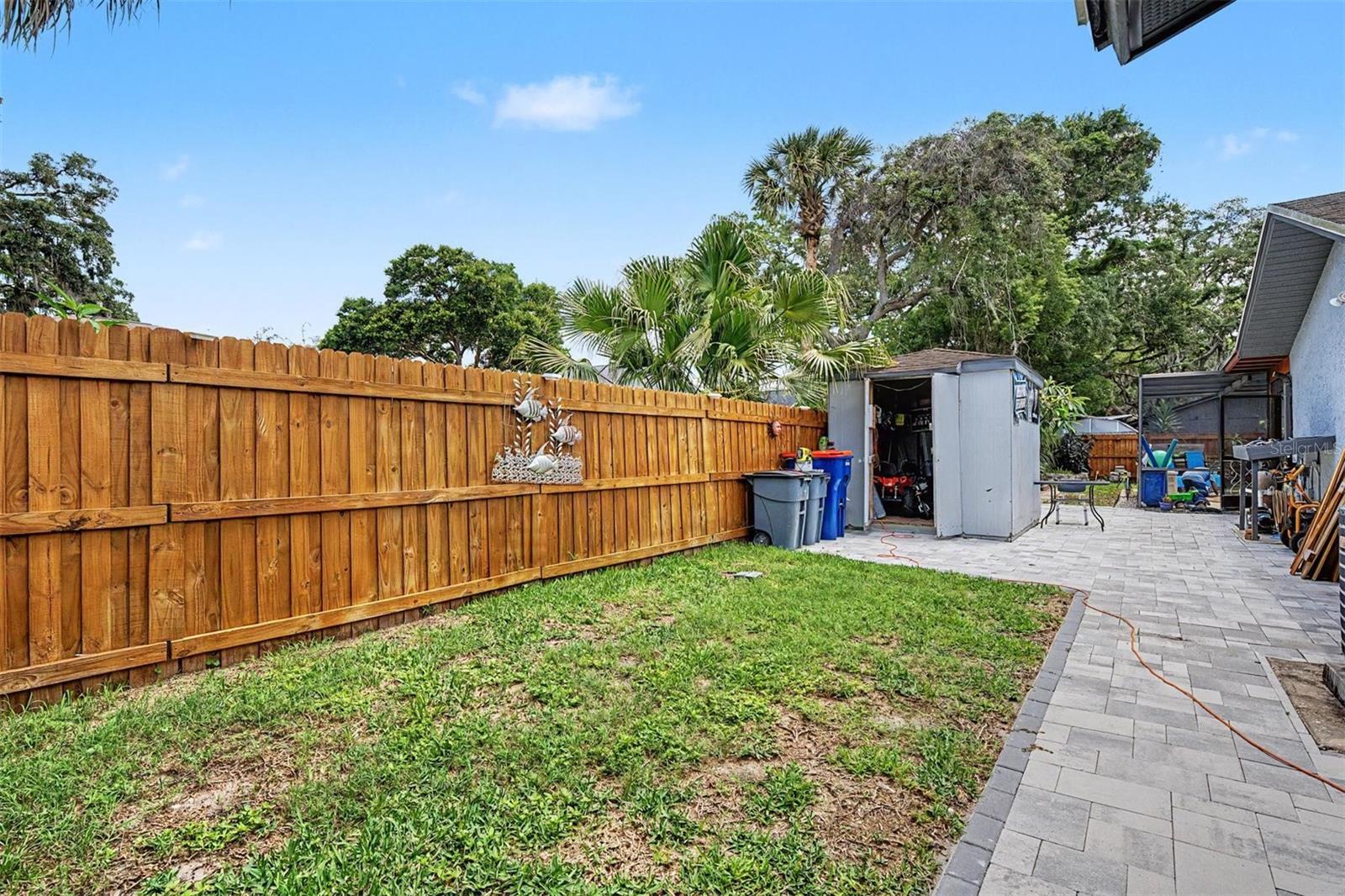 storage shed with double entry fence gates