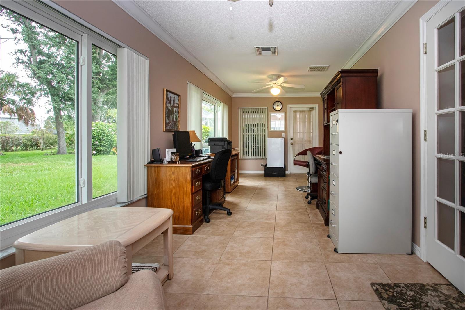 Florida Room has two sets of French doors and crown molding trim