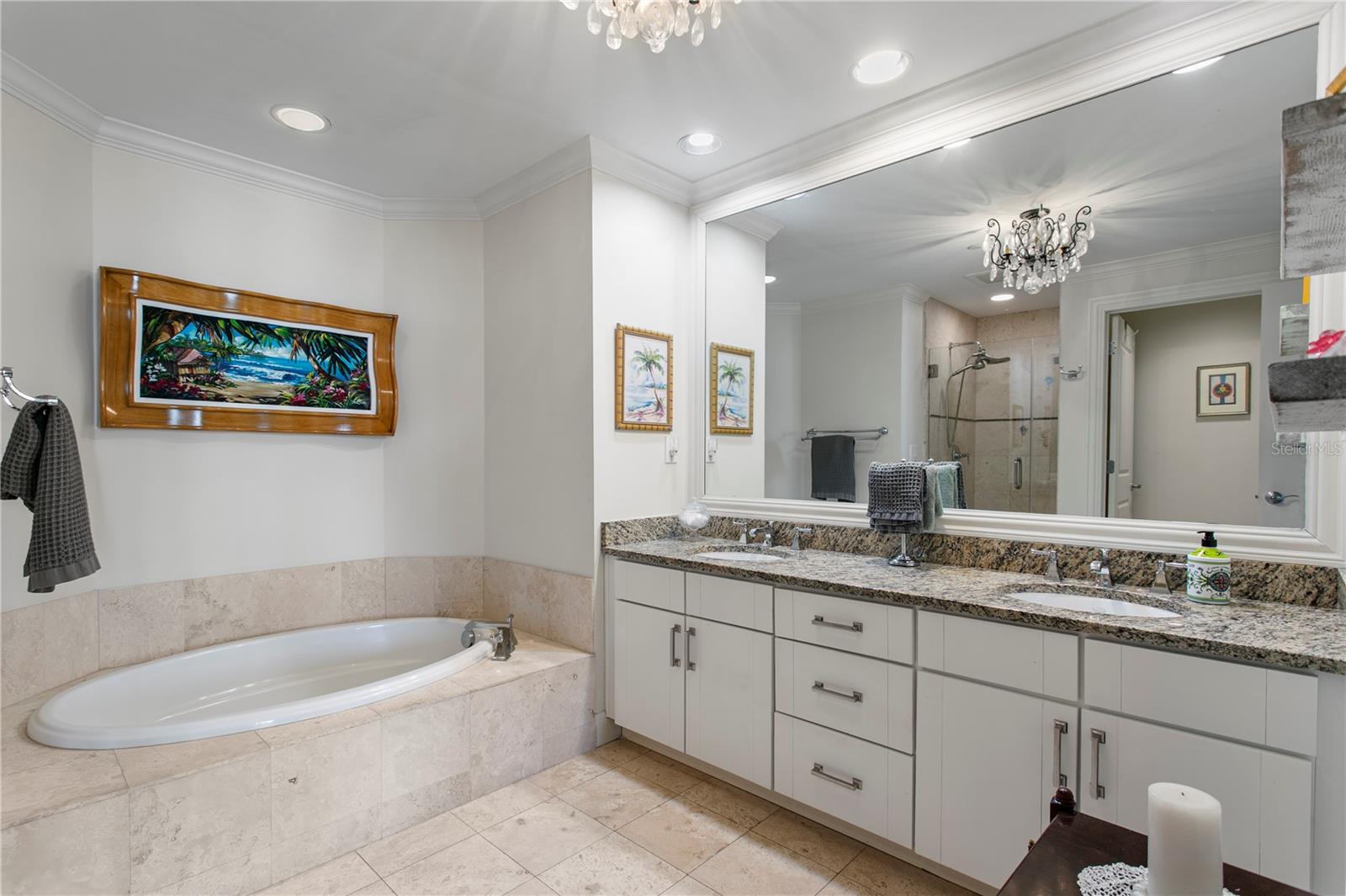 A spa-inspired en suite bath complete with dual vanities, a soaking tub, and separate water closet.