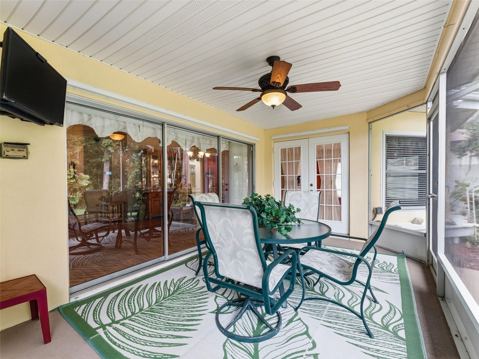 Sliders from Living Area & French doors from Kitchen area lead out to the Screened Patio