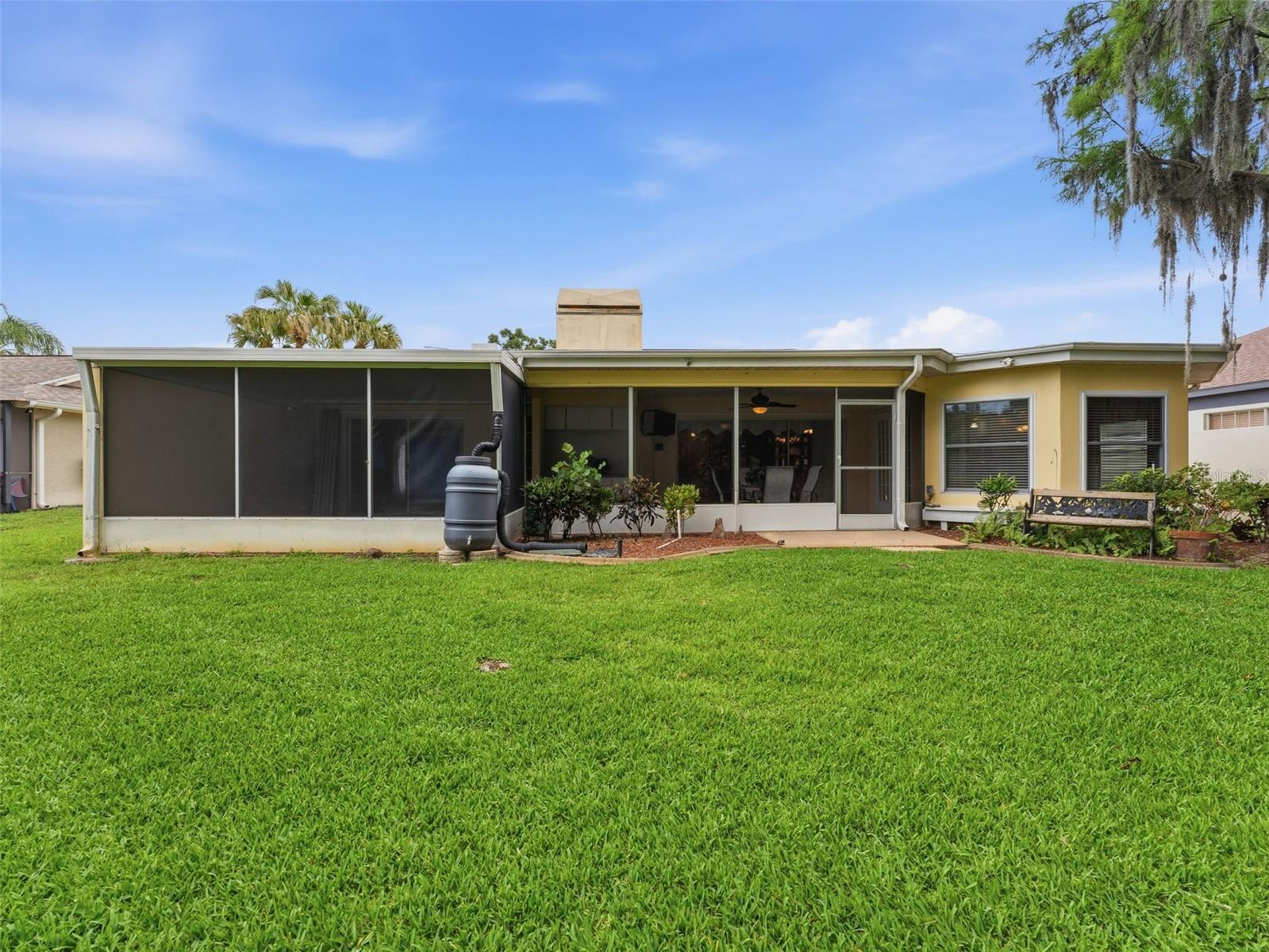Large screened Patio stretching across the rear of home