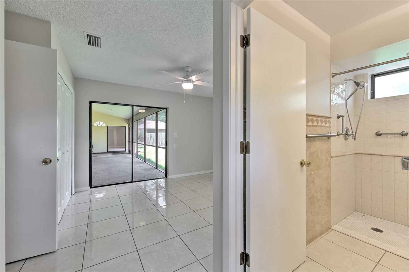 In Law Suite w/ separate entrance, full bathroom, 2 separate double bi-fold closets and slider door to back patio. Multigenerational Living