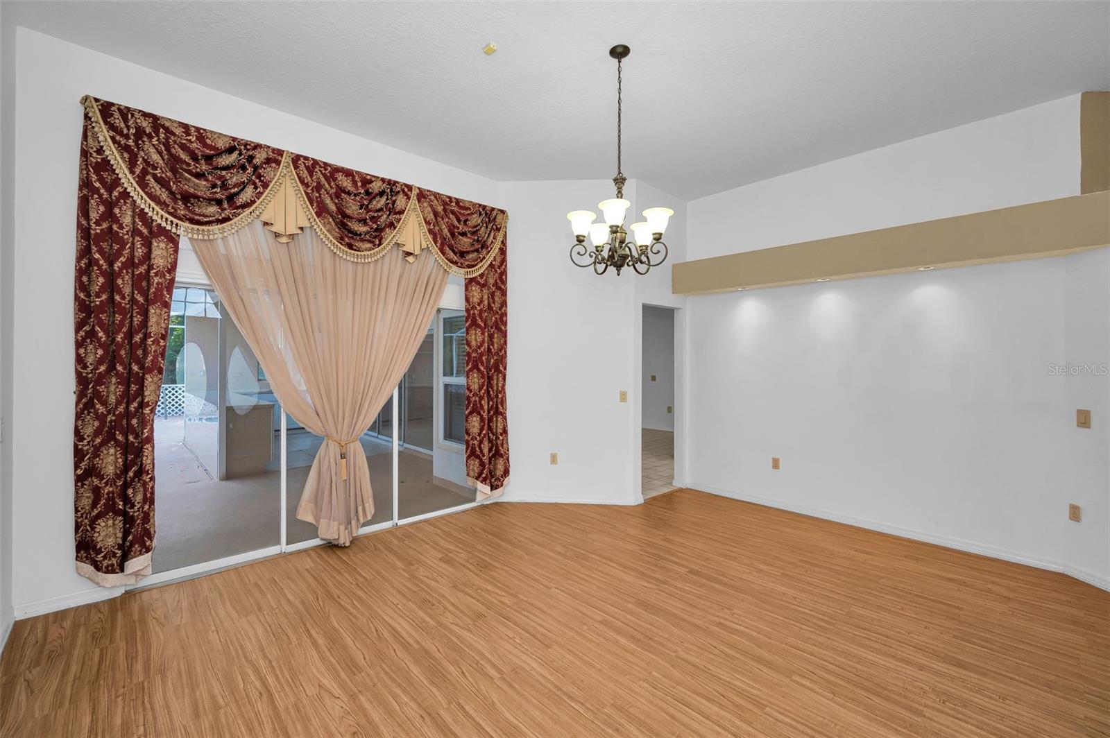 Formal Living Room With Access To The Kitchen & Screened-In Lanai