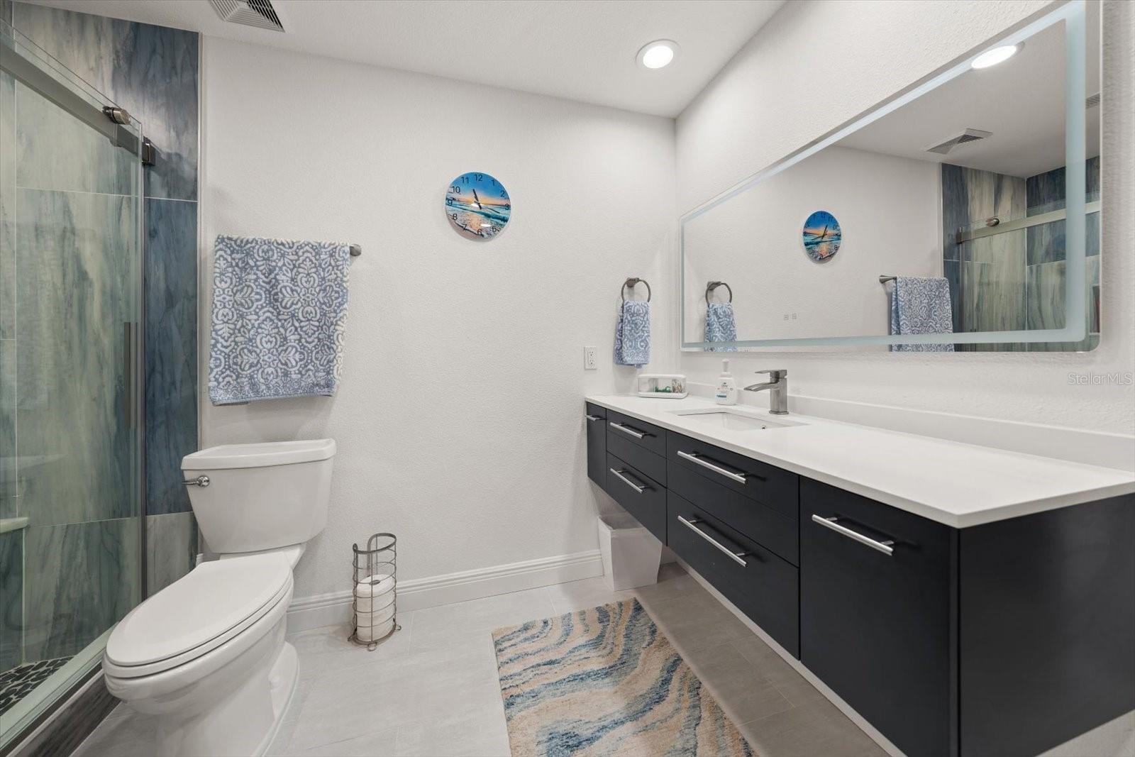 Stunning primary bathroom showcasing a contemporary floating vanity and high-end luxury accents.