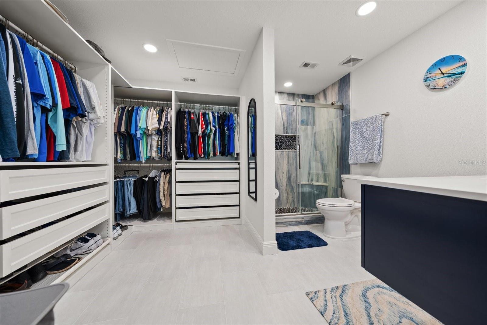 Custom-built walk-in closet with tons of storage, floor-to-ceiling shoe racks, and a cool velvet-lined jewelry drawer. Everything is perfectly organized and has its own spot in this dream closet.