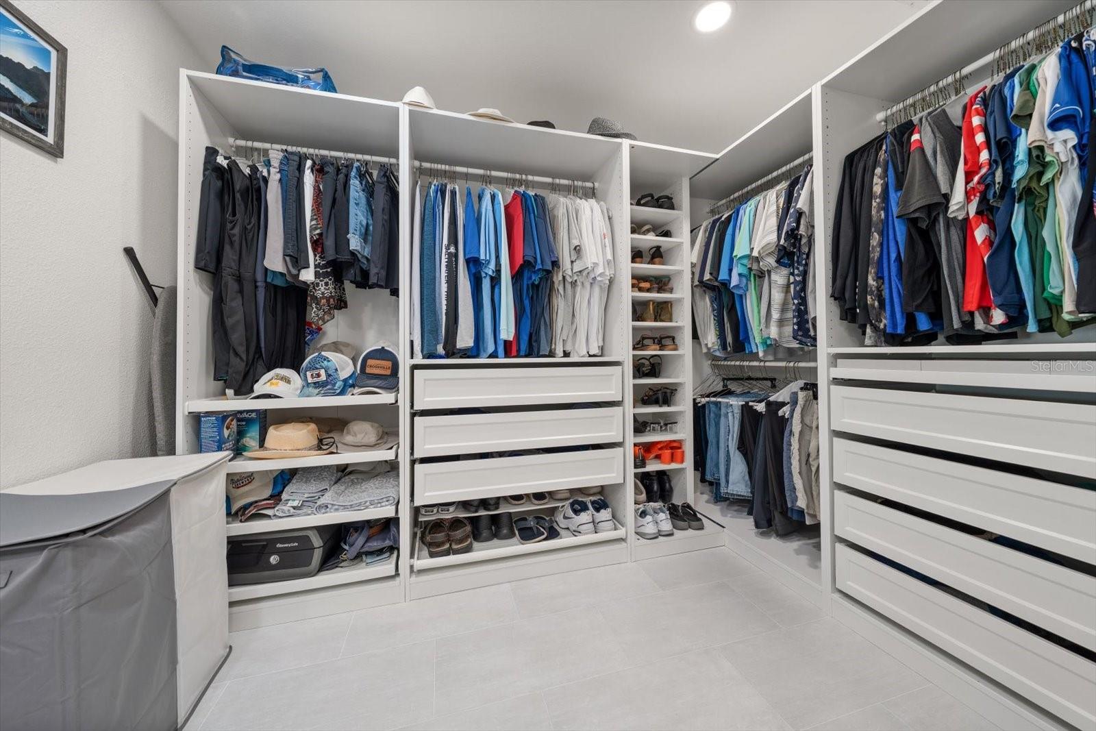 Custom-built walk-in closet with tons of storage, floor-to-ceiling shoe racks, and a cool velvet-lined jewelry drawer. Everything is perfectly organized and has its own spot in this dream closet.