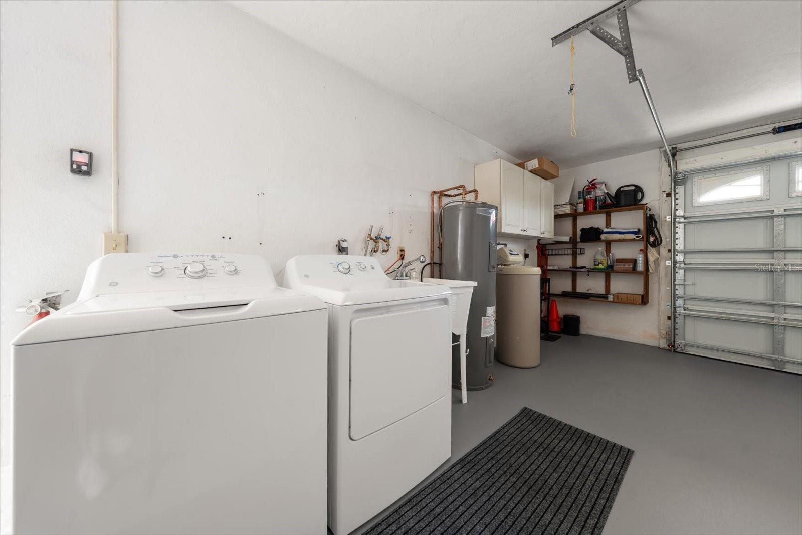 Brand new washer, dryer, water heater, garage door & opener. The garage also features additional storage shelving.