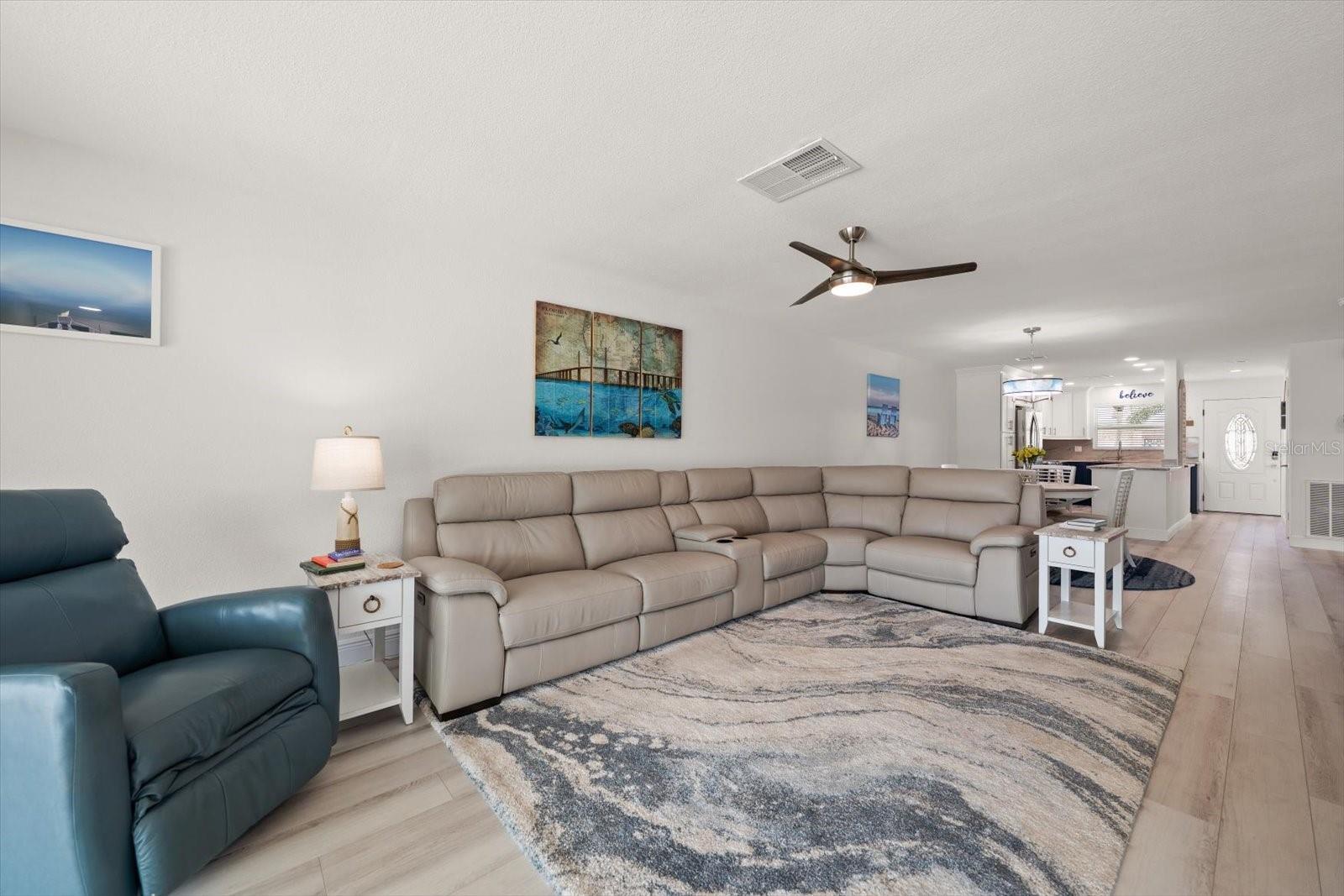 Living room opens to Dinning and Kitchen. 3 power recliners in the sectional!