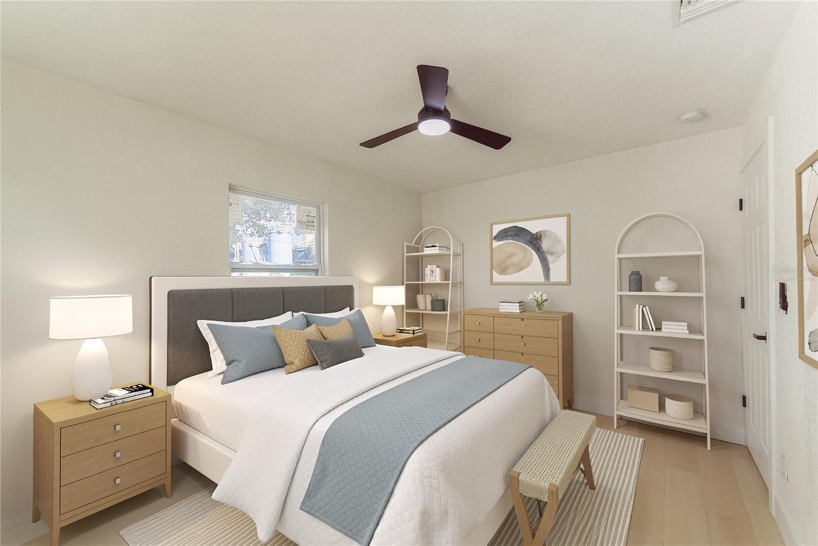 The second bedroom offers warm luxury vinyl flooring, a modern ceiling fan, and a new impact window, providing a bright and versatile space perfect for guests or a home office. (Virtually Staged.)