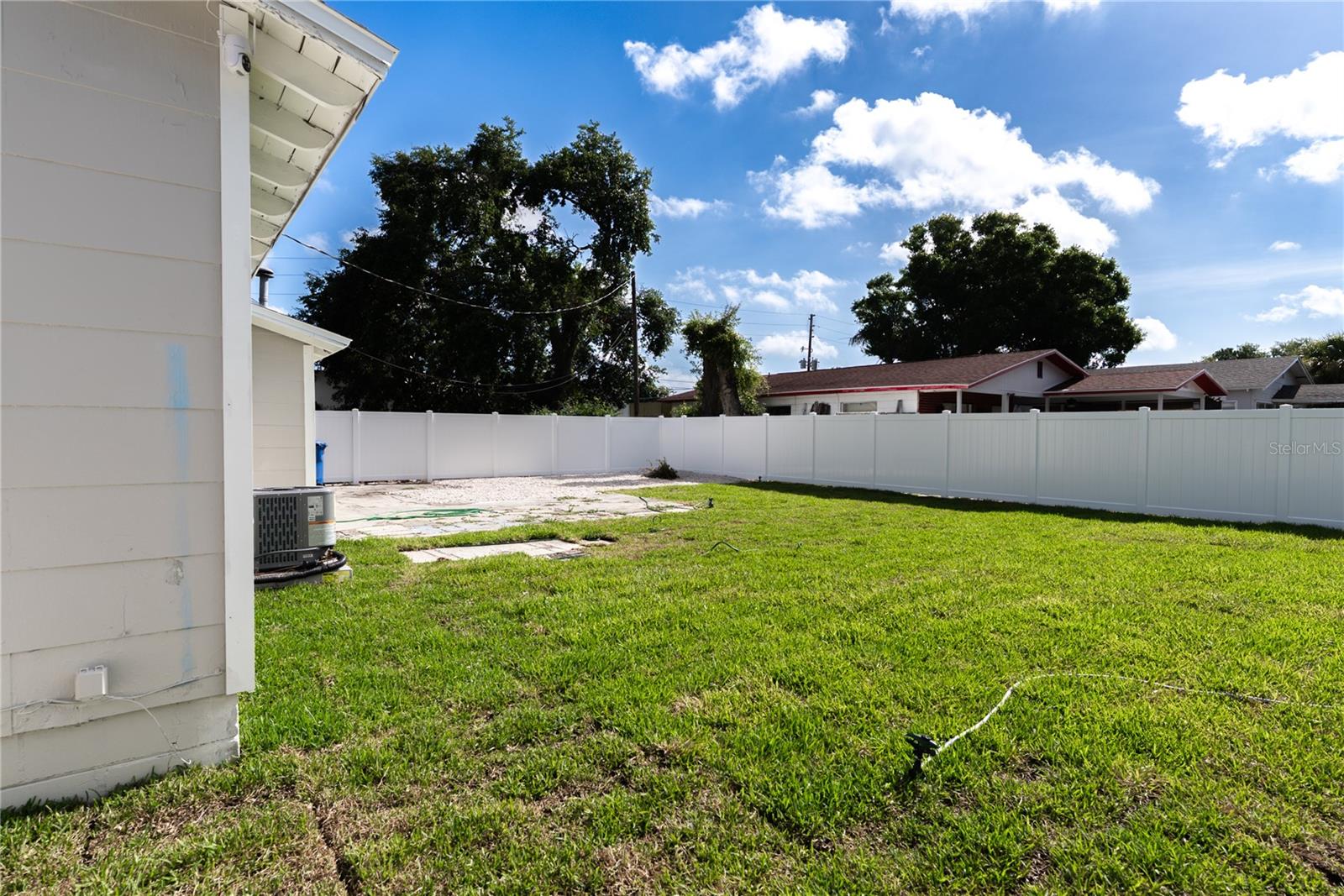 The fully fenced backyard offers a new watering system, and a brand new white vinyl privacy fence — plenty of space to create your own outdoor oasis.