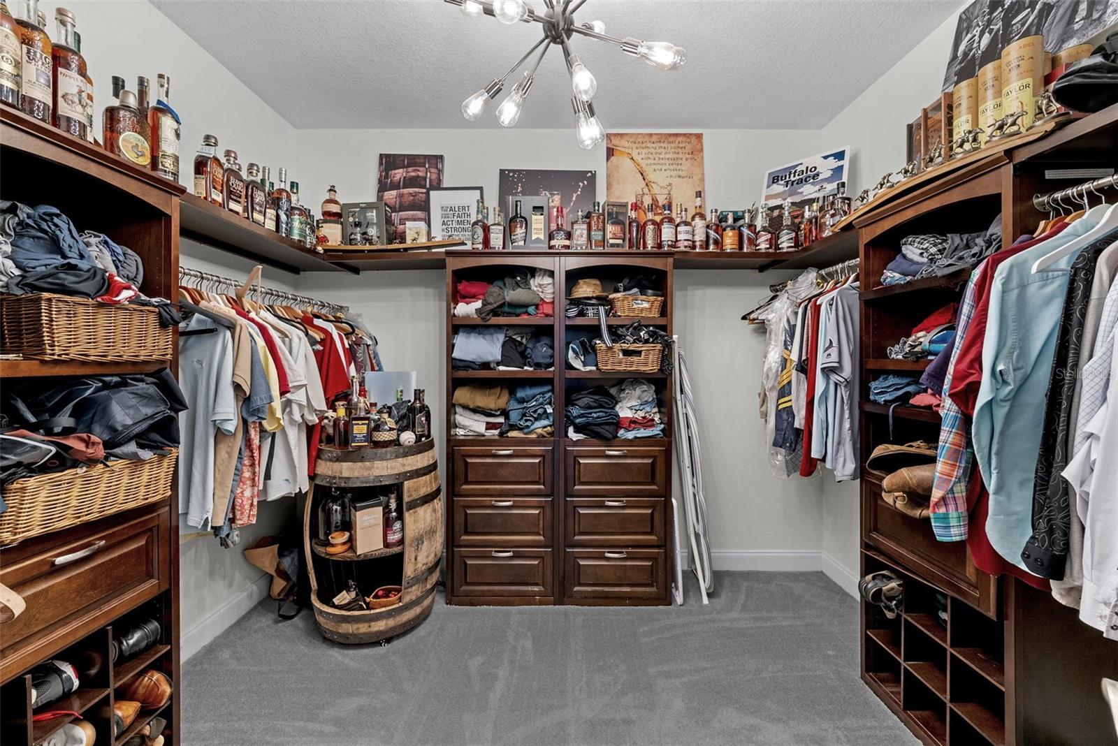 Large custom primary closet with built-ins and excellent storage.