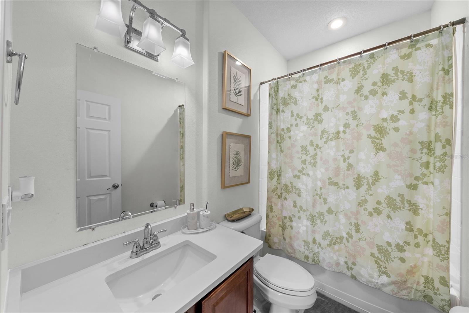 Full bath with tub/shower combination and updated vanity area.