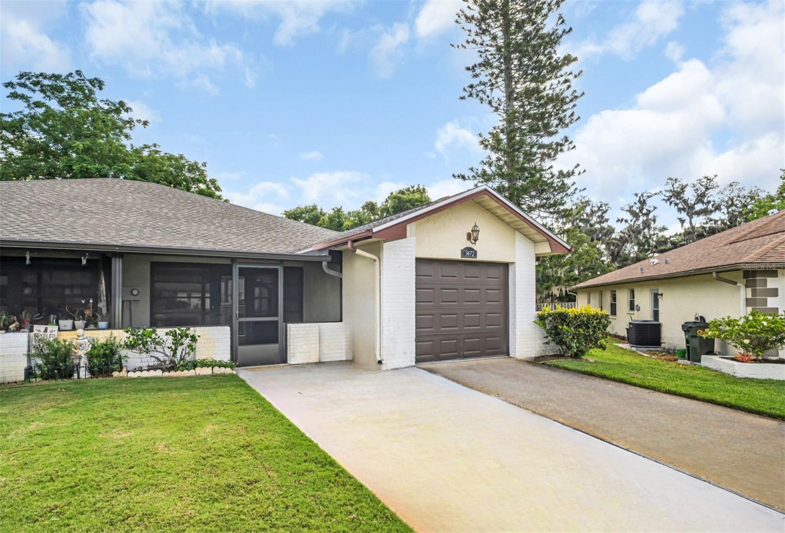 Widened 2-car driveway & 2025 front screened lanai~